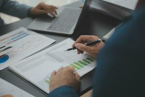 Financial Business team present. Business man hands hold documents with financial statistic stock photo, discussion, and analysis report data the charts and graphs. Finance Financial concept photo