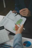 Financial Business team present. Business man hands hold documents with financial statistic stock photo, discussion, and analysis report data the charts and graphs. Finance Financial concept photo
