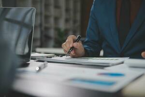 Financial Business team present. Business man hands hold documents with financial statistic stock photo, discussion, and analysis report data the charts and graphs. Finance Financial concept photo