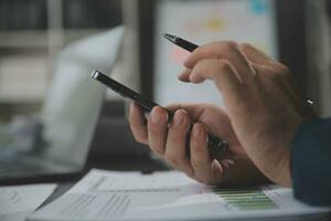 Financial Business team present. Business man hands hold documents with financial statistic stock photo, discussion, and analysis report data the charts and graphs. Finance Financial concept photo