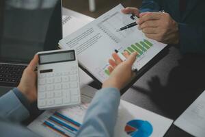 Financial Business team present. Business man hands hold documents with financial statistic stock photo, discussion, and analysis report data the charts and graphs. Finance Financial concept photo
