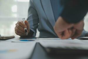 Financial Business team present. Business man hands hold documents with financial statistic stock photo, discussion, and analysis report data the charts and graphs. Finance Financial concept photo