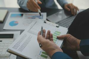 Financial Business team present. Business man hands hold documents with financial statistic stock photo, discussion, and analysis report data the charts and graphs. Finance Financial concept photo