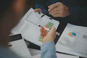 Financial Business team present. Business man hands hold documents with financial statistic stock photo, discussion, and analysis report data the charts and graphs. Finance Financial concept photo