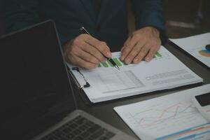 Financial Business team present. Business man hands hold documents with financial statistic stock photo, discussion, and analysis report data the charts and graphs. Finance Financial concept photo