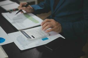 Financial Business team present. Business man hands hold documents with financial statistic stock photo, discussion, and analysis report data the charts and graphs. Finance Financial concept photo