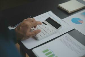 Financial Business team present. Business man hands hold documents with financial statistic stock photo, discussion, and analysis report data the charts and graphs. Finance Financial concept photo