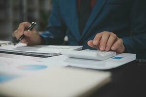 Financial Business team present. Business man hands hold documents with financial statistic stock photo, discussion, and analysis report data the charts and graphs. Finance Financial concept photo