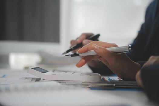Financial analysts analyze business financial reports on a digital tablet planning investment project during a discussion at a meeting of corporate showing the results of their successful teamwork. photo