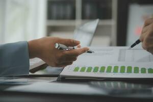 Financial Business team present. Business man hands hold documents with financial statistic stock photo, discussion, and analysis report data the charts and graphs. Finance Financial concept photo