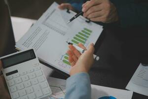 Financial Business team present. Business man hands hold documents with financial statistic stock photo, discussion, and analysis report data the charts and graphs. Finance Financial concept photo