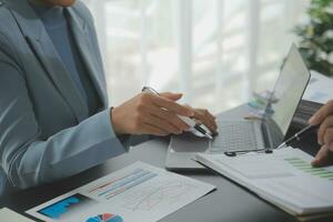 Financial Business team present. Business man hands hold documents with financial statistic stock photo, discussion, and analysis report data the charts and graphs. Finance Financial concept photo