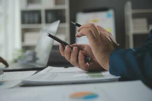 Financial Business team present. Business man hands hold documents with financial statistic stock photo, discussion, and analysis report data the charts and graphs. Finance Financial concept photo
