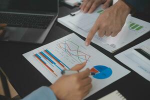Financial Business team present. Business man hands hold documents with financial statistic stock photo, discussion, and analysis report data the charts and graphs. Finance Financial concept photo