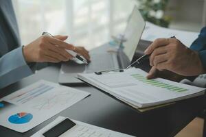 Financial Business team present. Business man hands hold documents with financial statistic stock photo, discussion, and analysis report data the charts and graphs. Finance Financial concept photo