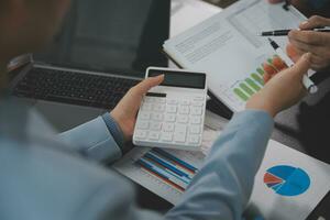 Financial Business team present. Business man hands hold documents with financial statistic stock photo, discussion, and analysis report data the charts and graphs. Finance Financial concept photo