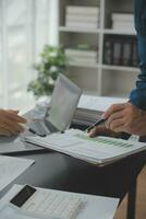 Financial Business team present. Business man hands hold documents with financial statistic stock photo, discussion, and analysis report data the charts and graphs. Finance Financial concept photo