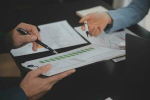 Financial Business team present. Business man hands hold documents with financial statistic stock photo, discussion, and analysis report data the charts and graphs. Finance Financial concept photo