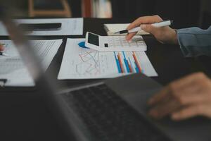 Financial Business team present. Business man hands hold documents with financial statistic stock photo, discussion, and analysis report data the charts and graphs. Finance Financial concept photo