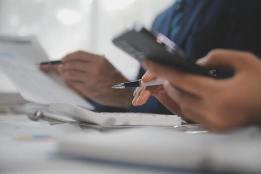 Financial analysts analyze business financial reports on a digital tablet planning investment project during a discussion at a meeting of corporate showing the results of their successful teamwork. photo