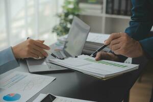 Financial Business team present. Business man hands hold documents with financial statistic stock photo, discussion, and analysis report data the charts and graphs. Finance Financial concept photo