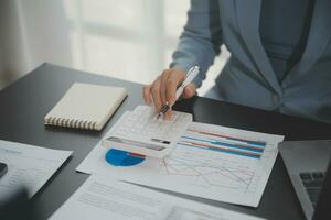 Financial Business team present. Business man hands hold documents with financial statistic stock photo, discussion, and analysis report data the charts and graphs. Finance Financial concept photo