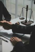 Businessman shaking hands to seal a deal with his partner lawyers or attorneys discussing a contract agreement photo