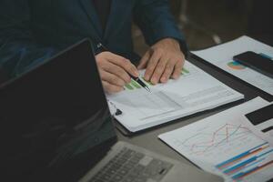 Financial Business team present. Business man hands hold documents with financial statistic stock photo, discussion, and analysis report data the charts and graphs. Finance Financial concept photo