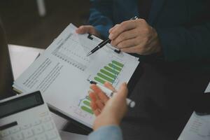 Financial Business team present. Business man hands hold documents with financial statistic stock photo, discussion, and analysis report data the charts and graphs. Finance Financial concept photo