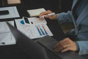 Financial Business team present. Business man hands hold documents with financial statistic stock photo, discussion, and analysis report data the charts and graphs. Finance Financial concept photo
