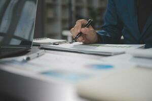 Financial Business team present. Business man hands hold documents with financial statistic stock photo, discussion, and analysis report data the charts and graphs. Finance Financial concept photo