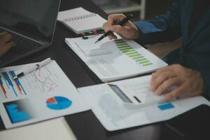 Financial Business team present. Business man hands hold documents with financial statistic stock photo, discussion, and analysis report data the charts and graphs. Finance Financial concept photo