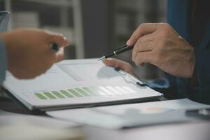 Financial Business team present. Business man hands hold documents with financial statistic stock photo, discussion, and analysis report data the charts and graphs. Finance Financial concept photo