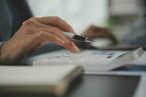 Financial Business team present. Business man hands hold documents with financial statistic stock photo, discussion, and analysis report data the charts and graphs. Finance Financial concept photo