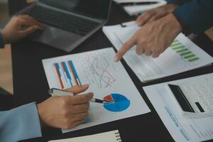 Financial Business team present. Business man hands hold documents with financial statistic stock photo, discussion, and analysis report data the charts and graphs. Finance Financial concept photo