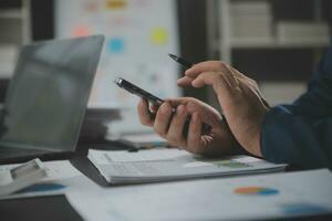 Financial Business team present. Business man hands hold documents with financial statistic stock photo, discussion, and analysis report data the charts and graphs. Finance Financial concept photo