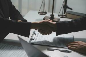 Businessman shaking hands to seal a deal with his partner lawyers or attorneys discussing a contract agreement photo