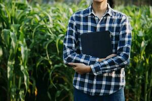 Agriculturist utilize the core data network in the Internet from the mobile to validate, test, and select the new crop method. Young farmers and tobacco farming photo
