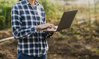 Agriculturist utilize the core data network in the Internet from the mobile to validate, test, and select the new crop method. Young farmers and tobacco farming photo