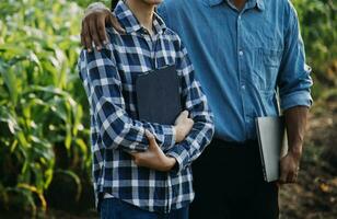 Agriculturist utilize the core data network in the Internet from the mobile to validate, test, and select the new crop method. Young farmers and tobacco farming photo