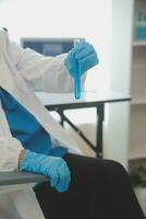 Health care researchers working in life science laboratory. Young female research scientist and senior male supervisor preparing and analyzing microscope slides in research lab. photo