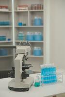 Health care researchers working in life science laboratory. Young female research scientist and senior male supervisor preparing and analyzing microscope slides in research lab. photo