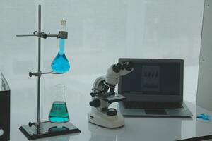 Health care researchers working in life science laboratory. Young female research scientist and senior male supervisor preparing and analyzing microscope slides in research lab. photo