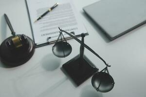 Business and lawyers discussing contract papers with brass scale on desk in office. Law, legal services, advice, justice and law concept picture with film grain effect photo