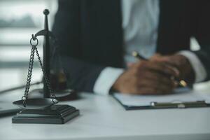 Business and lawyers discussing contract papers with brass scale on desk in office. Law, legal services, advice, justice and law concept picture with film grain effect photo