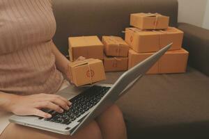 Business woman start up small business entrepreneur SME success .freelance woman working at home with Online Parcel delivery. SME and packaging deliveryconcept photo