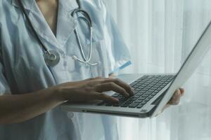 Doctor working with laptop computer in medical workspace office. doctor working on laptop computer in modern clinics office. search medical information. banner copy space photo