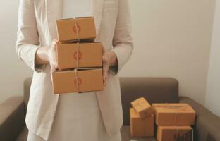 Business woman start up small business entrepreneur SME success .freelance woman working at home with Online Parcel delivery. SME and packaging deliveryconcept photo