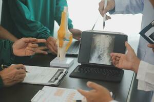 Group of doctors reading a document in meeting room at hospital photo