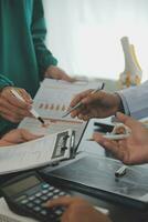 Group of doctors reading a document in meeting room at hospital photo